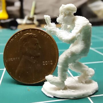 Tiny 3Dprint of a walking character, next to a penny