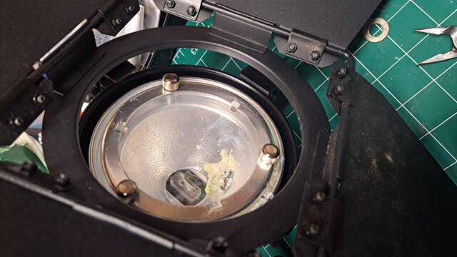 Close up of a spotlight with the remnants of an exploded halogen light bulb