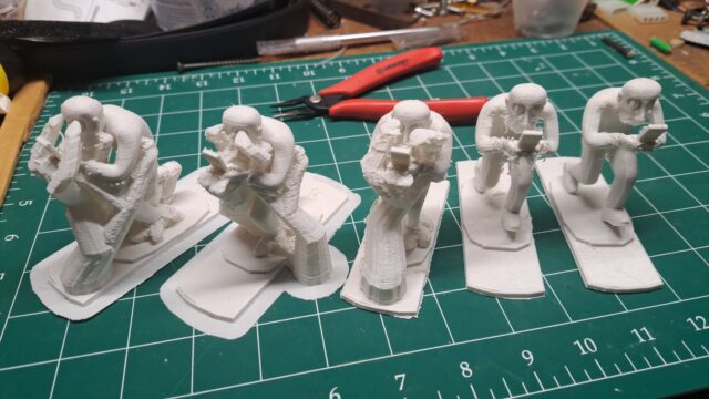 Five 3D prints of stages of a walk cycle