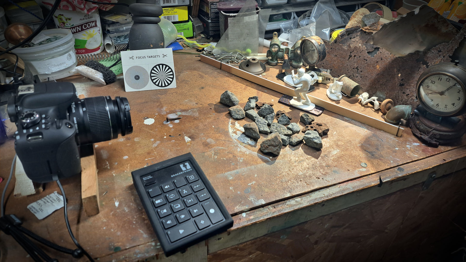 Messy table top with photo camera aimed at 3D printed figure