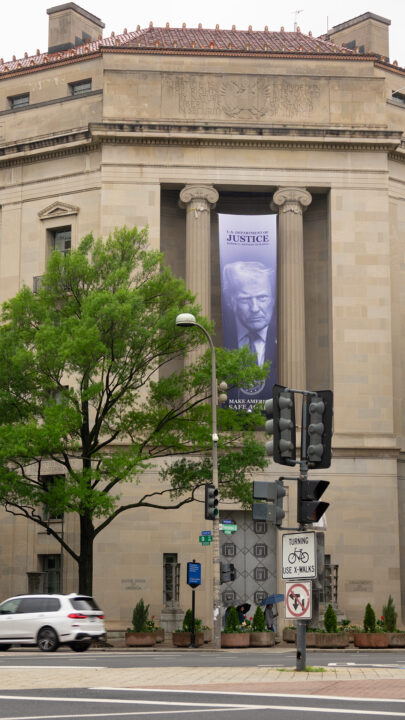 A huge banner of the current US president hanging on a Department of Justice builsing