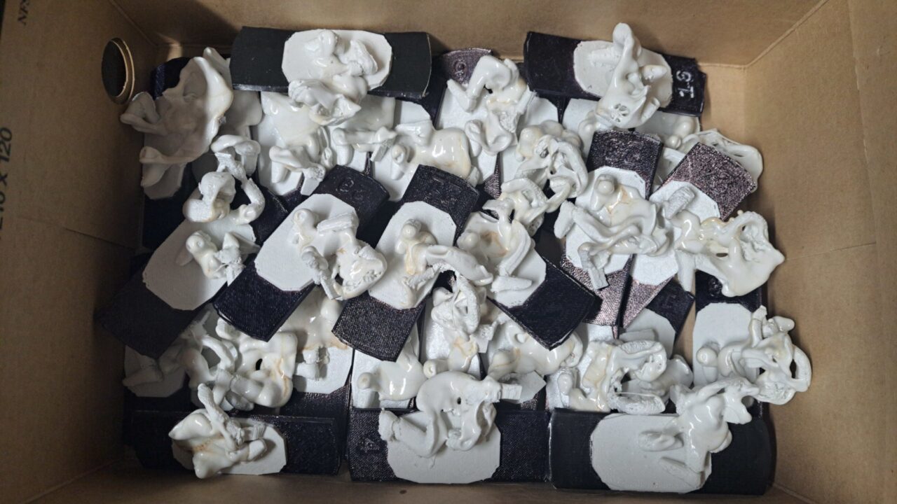 Partially melted 3D prints in a cardboard box